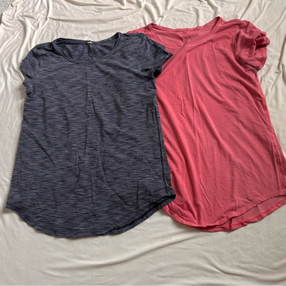 Two lululemon athletica Short Sleeve Crew Tee in Heather Charcoal and Coral.